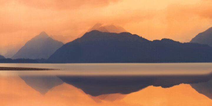 Homer Alaska panoramic seascape and Kenai Mountains landscape over Kachemak Bay at Bishop&rsquo;s Beach in United States on a foggy rainy autumn morning