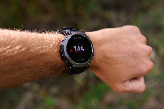 Smartwatch displaying high heart rate pulse during intense workout on male wrist
