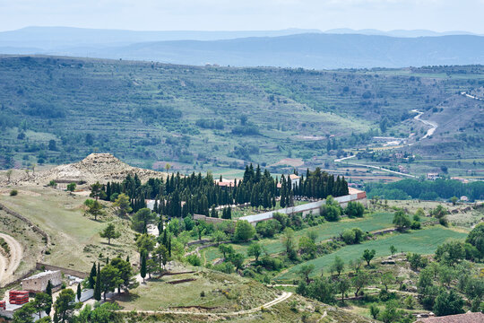 Aerial view of Cementeri Municipal de Morella with cypress trees and rural landscape, Spain