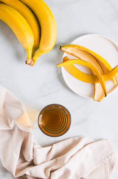 Evening sleep drink made from banana peel in a glass on the table top and  vertical view
