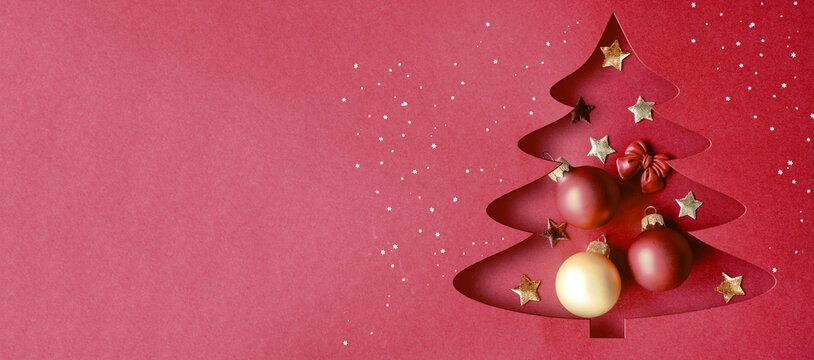 Paper christmas tree with gold star topper and metallic ornaments isolated on a transparent background.
