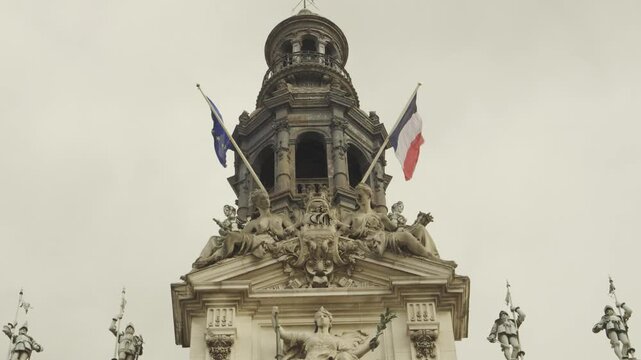 Historic Clock Tower with French Flags at H&ocirc;tel de Ville in Paris, France