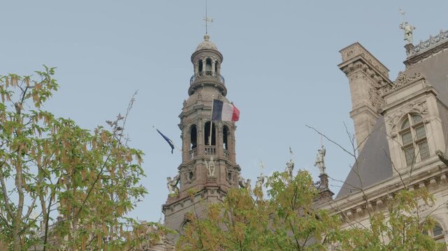 Title: Historic Clock Tower and Ornate Architecture of H&ocirc;tel de Ville in Paris, France