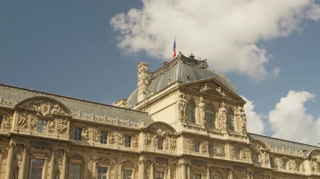 Historic Louvre Palace Facade with French Flag and Ornate Architecture in Paris, France
