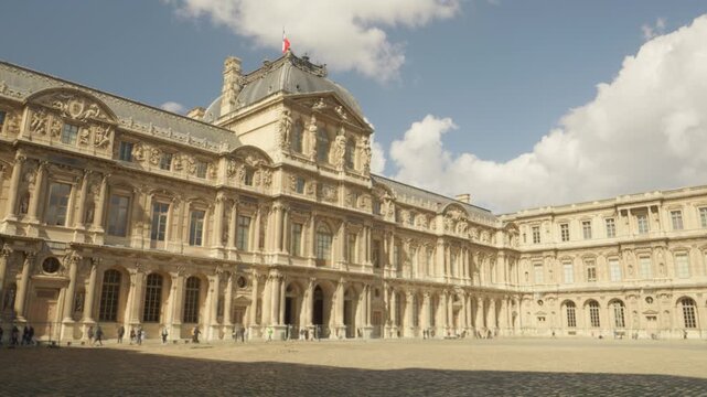 Louvre Museum Courtyard with Historic French Architecture Under Blue Sky in Paris, France