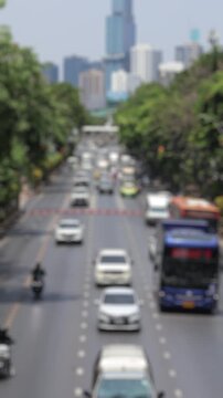 Bokeh view of road traffic in Bangkok, Thailand. Blurred background vertical footage.