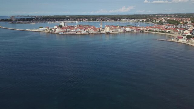 Aerial view of historic Umag old town peninsula coastline and breakwater in Istria Croatia