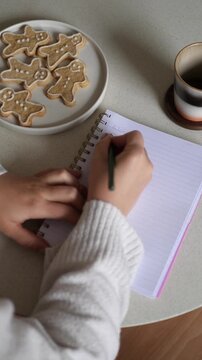 Woman Writing Christmas Wish List in Journal, Vertical UGC Style