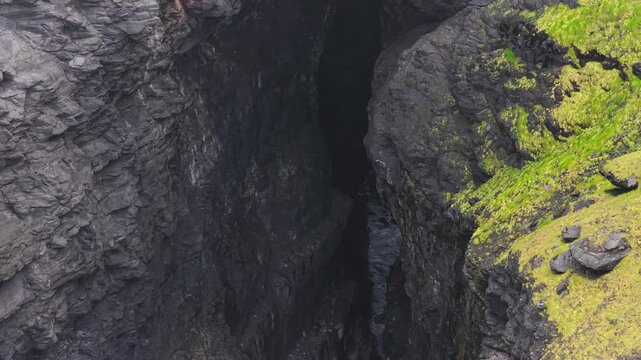 Close drone view of a rocky sea passage at Hag's Head, County Clare, Ireland
