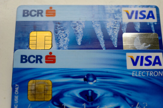 Bucharest, Romania - May 24, 2023: Close-up view of BCR Erste Group Visa and Visa Electron plastic debit cards featuring EMV microchips and blue water design.