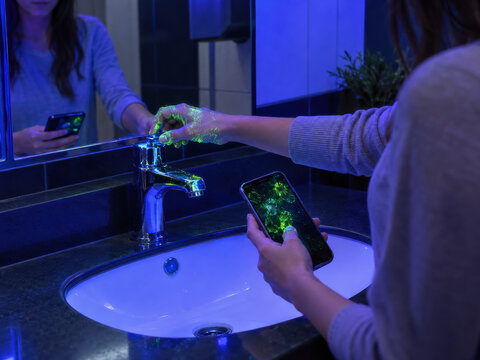 UV LIGHT REVEALS GERMS AROUND PUBLIC WASHROOM SINK