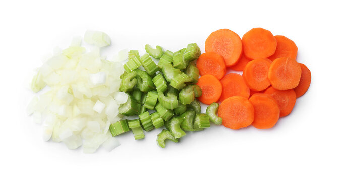 Cut carrots, onions and celery isolated on white, top view
