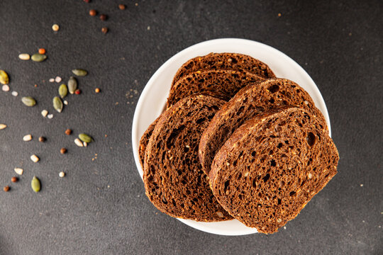 Black bread whole-grain rye flour slices of dark bread healthy eating delicious snack fresh, gourmet, rustic food background on the table top view copy space