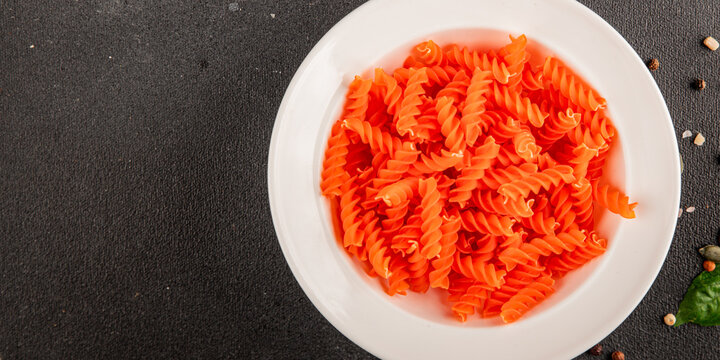 Red lentil pasta fusilli gluten-free fresh pasta healthy eating tasty snack gourmet, rustic food background on the table top view copy space  vegetarian and vegan food