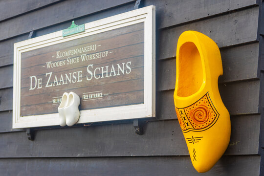 Signboard of the traditional Klompenmakerij wooden shoe workshop with a giant clog decoration on a house wall in Zaanse Schans, Zaandam, Netherlands