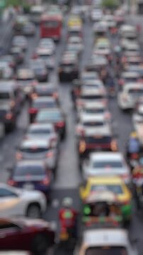 Bokeh view of road traffic near Central World shopping mall, Bangkok, Thailand. Blurred background vertical footage.