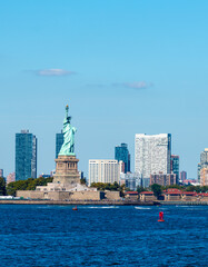 Close up of the Statue of Liberty with Jersey City skyline in the background © Gabriele Maltinti