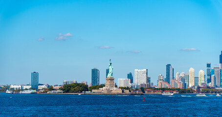 Statue of Liberty viewed from the water with New Jersey skyline in the background © Gabriele Maltinti