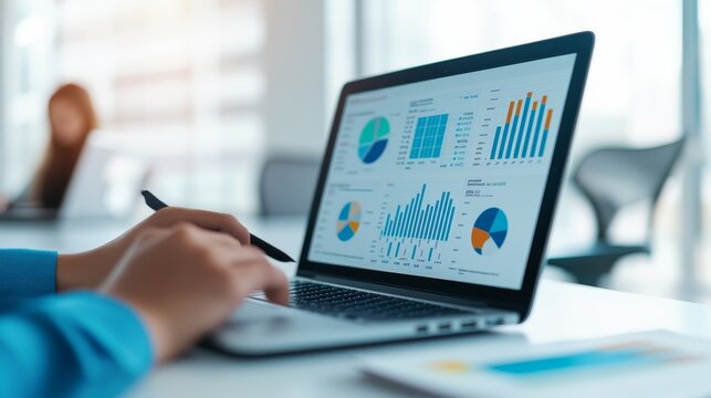 Golden Afternoon Framed by Clear Data Visualizations: Anonymous Analyst Reviewing Laptop Graphs In Bright Office Co &acirc;&euro;&ldquo; Skyline Study 2