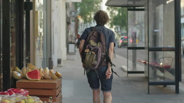 A person existing a high street grocery store in London West Hampstead