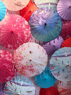 Colorful paper umbrellas create a vibrant display in a lively setting