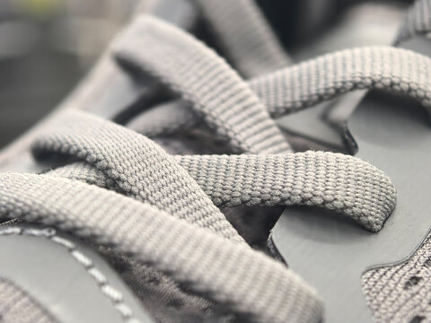 Exploring the intricate details of a stylish gray sneaker lace