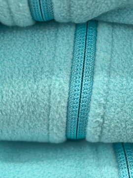 Soft turquoise towels neatly stacked with elegant detailing
