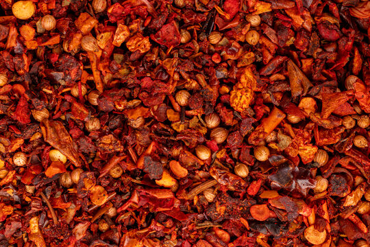 Mixed chili flakes and coriander seeds texture background