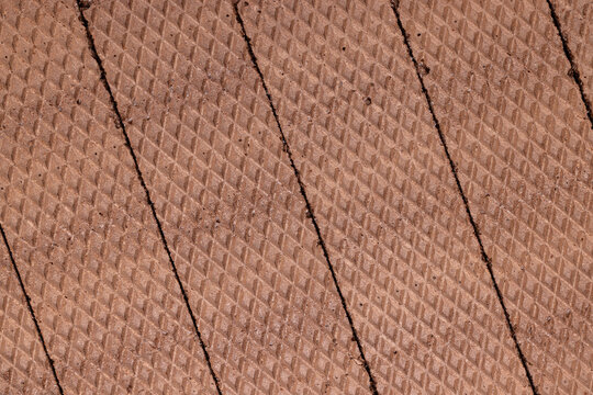 Brown waffle surface creating geometric food background pattern