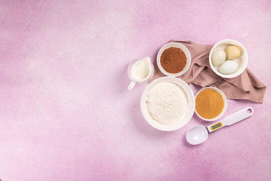 Baking ingredients with flour, sugar, cocoa, eggs, milk