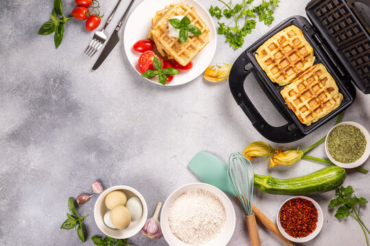 Healthy zucchini waffles with fresh ingredients cooking