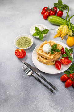 Zucchini waffles stack with fresh tomatoes and basil