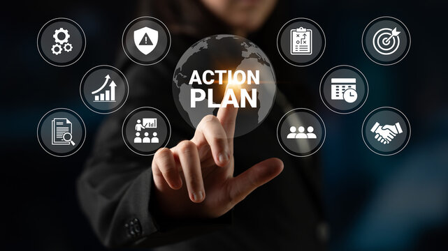 A focused businesswoman interacts with a digital touchscreen displaying an action plan and various business icons, symbolizing strategy and teamwork in a modern workspace. Ledger