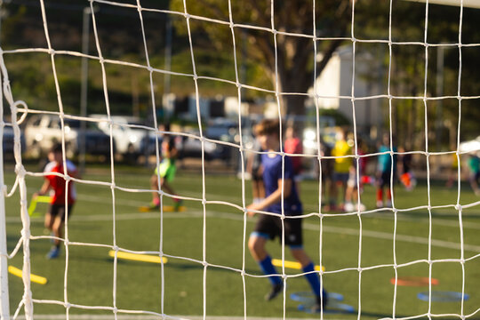 abstracted view of goalie net and goalie in late afternoon light