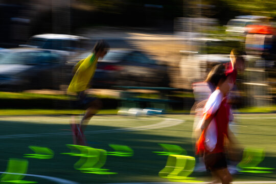 blur of color and motion, soccer game at sunset