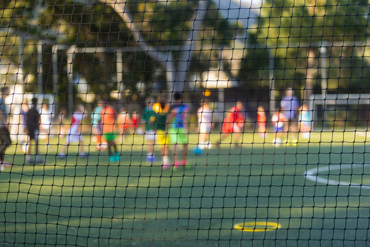 abstracted view of goalie net and goalie in late afternoon light