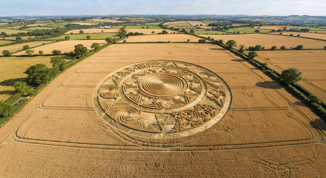 Aerial View of Mysterious Circular Crop Circle in Golden Wheat Field in Rural Countryside