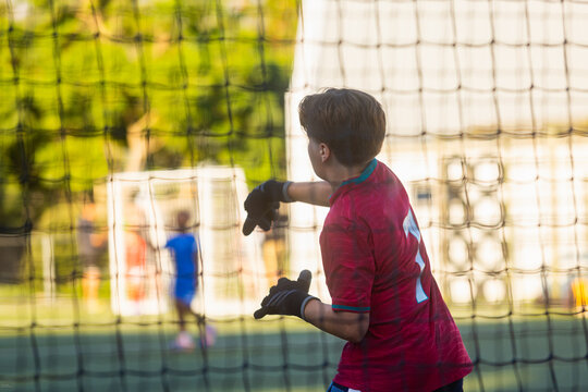 abstracted view of goalie net and goalie in late afternoon light