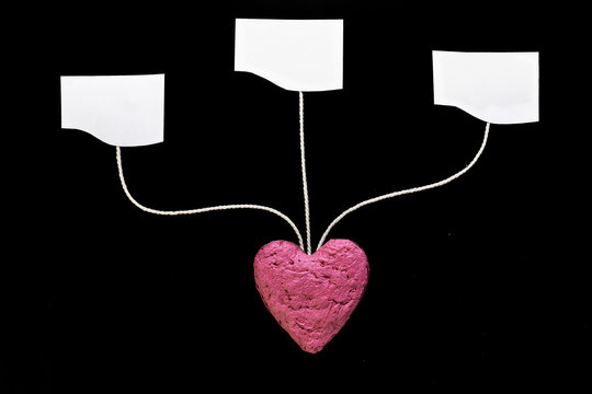 Pink Heart With Three Blank Tags on Black Background Symbolizing Love, Choice, and Communication