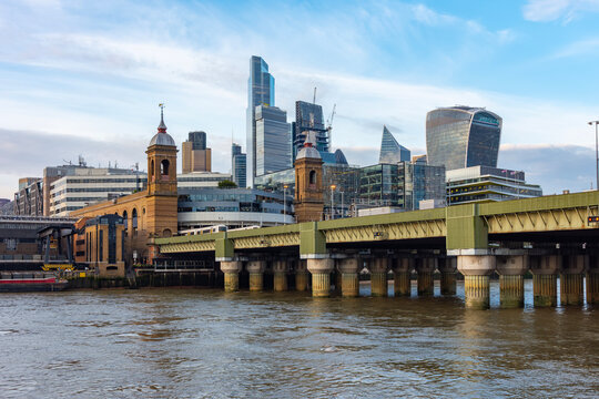 Cannon Street Railway bridge over Thames river and City of London skyscrapers, UK