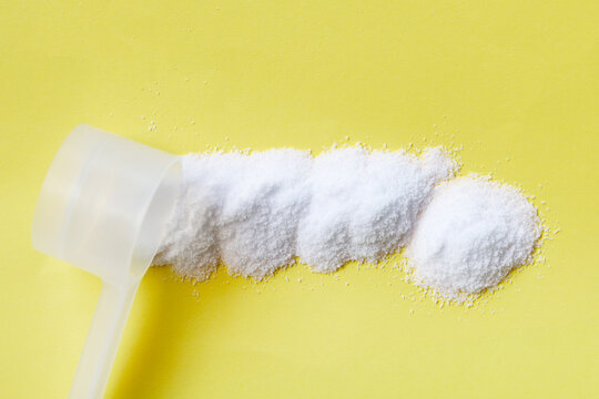 White creatine powder, used as a pre-workout supplement for gym and fitness.