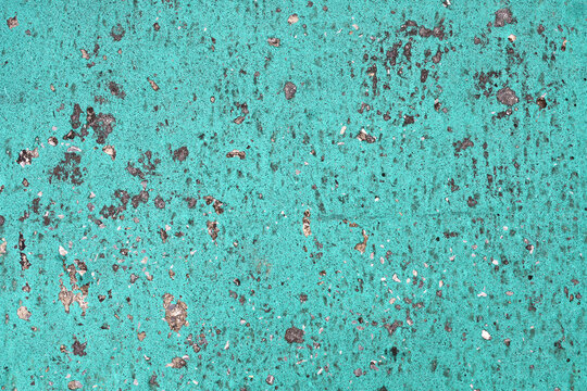 Paint peeling on concrete surface.
