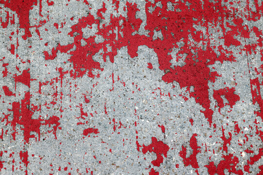 Paint peeling on concrete surface.