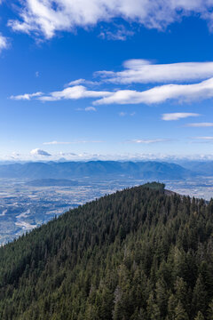 Forest-Covered Mountain Overlooking Chilliwack Valley With Blue Sky and Distant Peaks, BC Canada