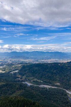 Aerial Landscape of Chilliwack BC Valley With Mountains, Forests and Dramatic Cloudy Sky