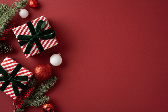 Festive red Christmas gifts with green velvet bows and ornaments for Merry Christmas and Happy New Year celebration