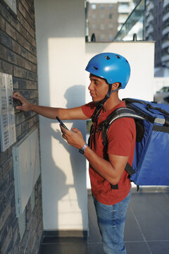 Delivery courier ringing the bell at destination address for food order
