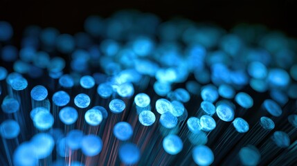 Fototapeta premium Macro shot of glowing blue fiber optic circles, dark background, luminescent abstract pattern, techno wallpaper