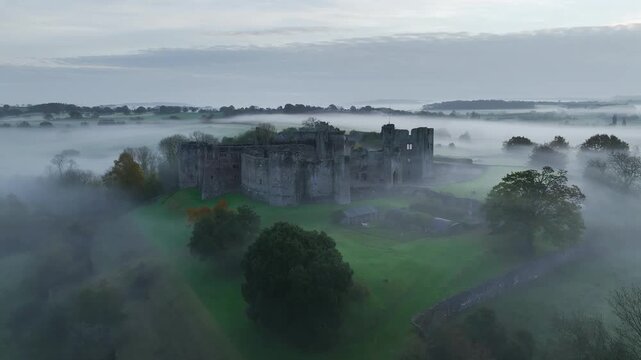 Raglan Castle in the fog at dawn, Monmouthshire, Wales, England, United Kingdom