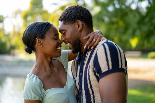 Happy young couple expressing love and intimacy in park